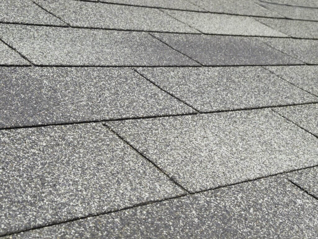 close up picture of 3-tab composition shingles on a roof
