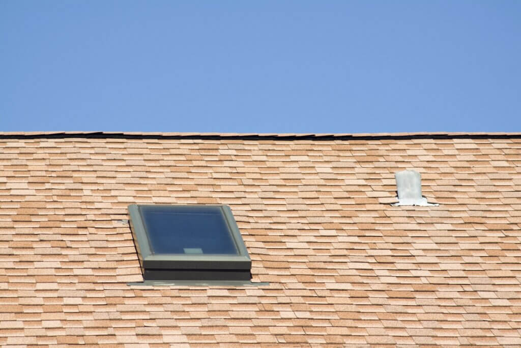 a lone skylight on a tan roof | roof leak repair skylight